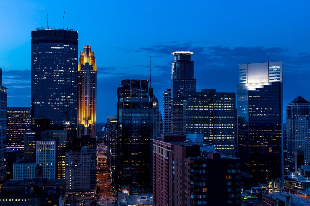 Minneapolis skyline at dusk with IDS Center, Wells Fargo Center, and Capella Tower
